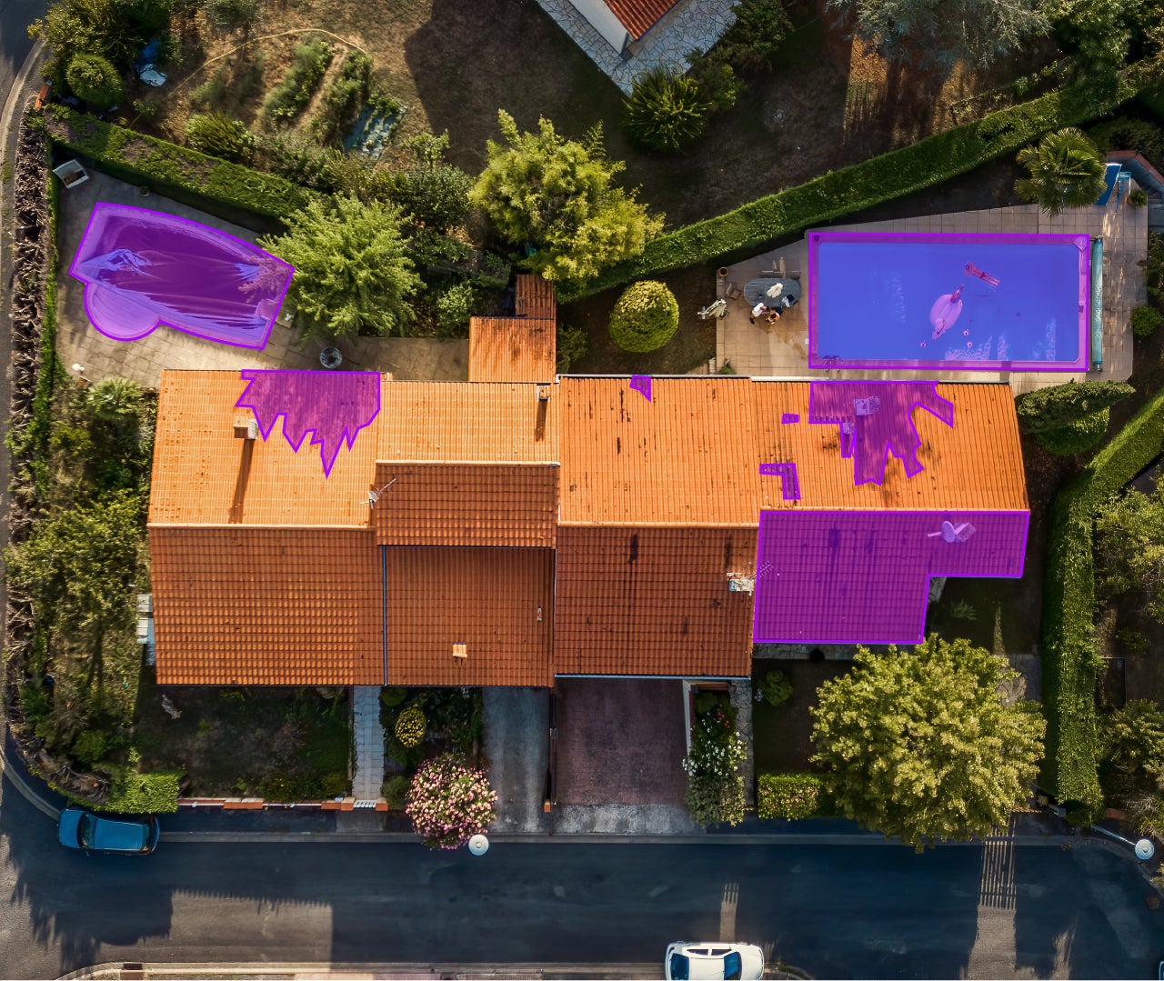 An aerial view of a red colored roof of a house.
